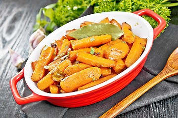 Image showing Carrots fried in pan on black board