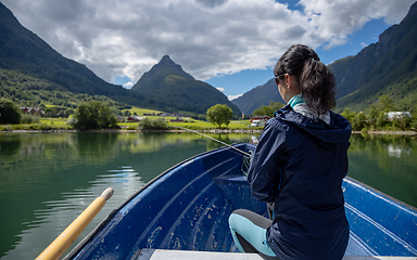 Image showing Woman fishing on Fishing rod spinning in Norway.