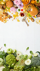 Image showing Fast and healthy food compared on white background. Unhealthy set including burgers, sauces, french fries in comparison with vegetables, fruits, organic food