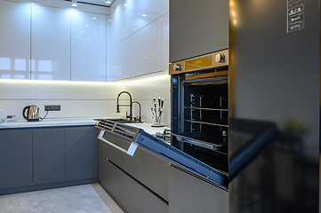 Image showing Luxury gray modern kitchen interior, oven\'s door opened