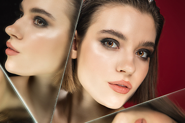 Image showing Portrait of female fashion model with reflections on mirrors around her face. Style and beauty concept. Close up.