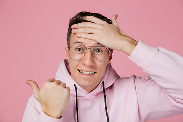 Image showing Caucasian man\'s portrait isolated on pink studio background with copyspace