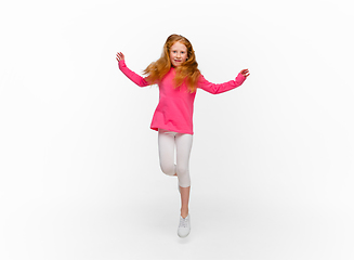 Image showing Happy redhair girl isolated on white studio background. Looks happy, cheerful, sincere. Copyspace. Childhood, education, emotions concept