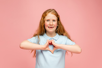 Image showing Happy redhair girl isolated on pink studio background. Looks happy, cheerful, sincere. Copyspace. Childhood, education, emotions concept