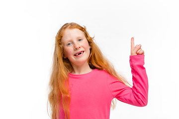 Image showing Happy redhair girl isolated on white studio background. Looks happy, cheerful, sincere. Copyspace. Childhood, education, emotions concept