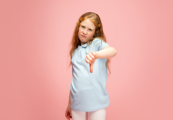 Image showing Happy redhair girl isolated on pink studio background. Looks happy, cheerful, sincere. Copyspace. Childhood, education, emotions concept