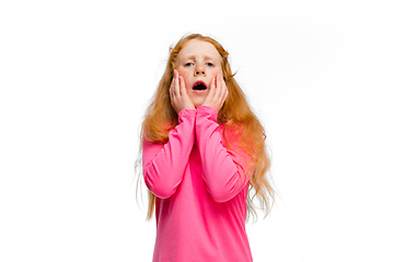 Image showing Happy redhair girl isolated on white studio background. Looks happy, cheerful, sincere. Copyspace. Childhood, education, emotions concept