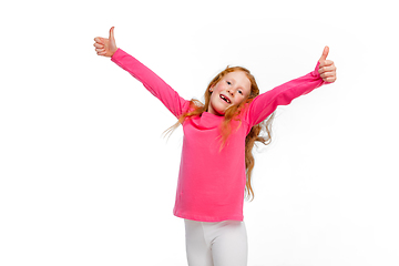 Image showing Happy redhair girl isolated on white studio background. Looks happy, cheerful, sincere. Copyspace. Childhood, education, emotions concept