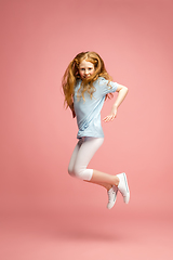 Image showing Happy redhair girl isolated on pink studio background. Looks happy, cheerful, sincere. Copyspace. Childhood, education, emotions concept