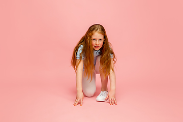 Image showing Happy redhair girl isolated on pink studio background. Looks happy, cheerful, sincere. Copyspace. Childhood, education, emotions concept