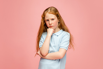 Image showing Happy redhair girl isolated on pink studio background. Looks happy, cheerful, sincere. Copyspace. Childhood, education, emotions concept