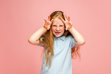 Image showing Happy redhair girl isolated on pink studio background. Looks happy, cheerful, sincere. Copyspace. Childhood, education, emotions concept