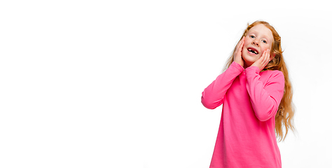 Image showing Happy redhair girl isolated on white studio background. Looks happy, cheerful, sincere. Copyspace. Childhood, education, emotions concept