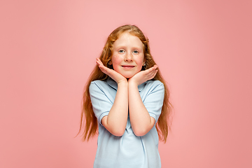 Image showing Happy redhair girl isolated on pink studio background. Looks happy, cheerful, sincere. Copyspace. Childhood, education, emotions concept