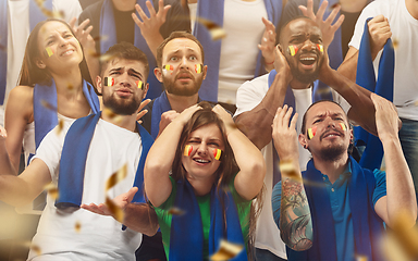 Image showing Belgian football, soccer fans cheering their team with a blue scarfs at stadium. Excited fans cheering a goal, supporting favourite players