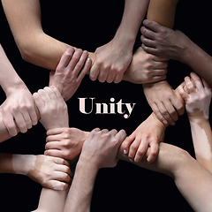 Image showing African and caucasian hands gesturing on gray studio background, tolerance and equality concept