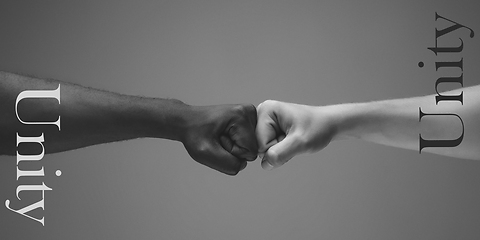 Image showing African and caucasian hands gesturing on gray studio background, tolerance and equality concept. Unity.