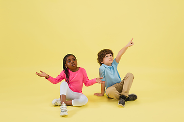 Image showing Childhood and dream about big and famous future. Pretty little kids isolated on yellow background