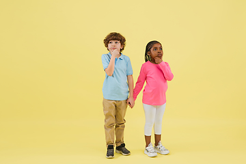 Image showing Childhood and dream about big and famous future. Pretty little kids isolated on yellow background