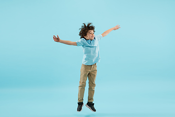 Image showing Childhood and dream about big and famous future. Pretty little boy isolated on blue background