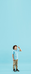 Image showing Childhood and dream about big and famous future. Pretty little boy isolated on blue background