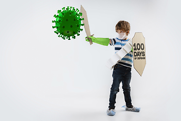 Image showing Little caucasian boy as a warrior in fight with coronavirus pandemic, with a shield, a sword and a toilet paper bandoleer.