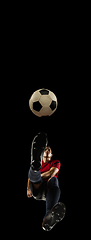 Image showing Young caucasian football, soccer player in action, motion isolated on black background, look from the bottom. Concept of sport, movement, energy and dynamic.