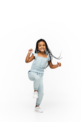 Image showing Happy longhair brunette little girl isolated on white studio background. Looks happy, cheerful, sincere. Copyspace. Childhood, education, emotions concept