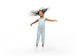 Image showing Happy longhair brunette little girl isolated on white studio background. Looks happy, cheerful, sincere. Copyspace. Childhood, education, emotions concept
