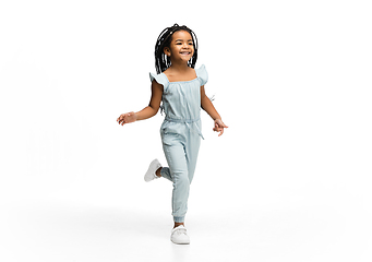 Image showing Happy longhair brunette little girl isolated on white studio background. Looks happy, cheerful, sincere. Copyspace. Childhood, education, emotions concept