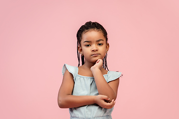 Image showing Happy longhair brunette little girl isolated on pink studio background. Looks happy, cheerful, sincere. Copyspace. Childhood, education, emotions concept