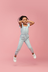 Image showing Happy longhair brunette little girl isolated on pink studio background. Looks happy, cheerful, sincere. Copyspace. Childhood, education, emotions concept