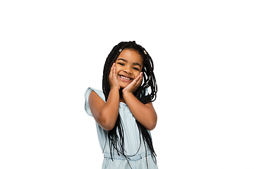 Image showing Happy longhair brunette little girl isolated on white studio background. Looks happy, cheerful, sincere. Copyspace. Childhood, education, emotions concept