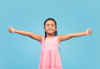 Image showing Happy longhair brunette little girl isolated on blue studio background. Looks happy, cheerful, sincere. Copyspace. Childhood, education, emotions concept