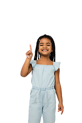 Image showing Happy longhair brunette little girl isolated on white studio background. Looks happy, cheerful, sincere. Copyspace. Childhood, education, emotions concept