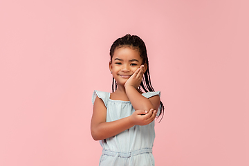 Image showing Happy longhair brunette little girl isolated on pink studio background. Looks happy, cheerful, sincere. Copyspace. Childhood, education, emotions concept