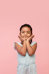 Image showing Happy longhair brunette little girl isolated on pink studio background. Looks happy, cheerful, sincere. Copyspace. Childhood, education, emotions concept