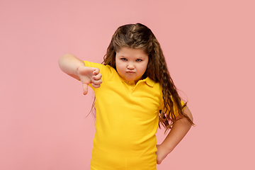 Image showing Happy caucasian little girl isolated on studio background. Looks happy, cheerful, sincere. Copyspace. Childhood, education, emotions concept