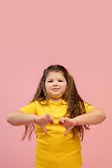 Image showing Happy caucasian little girl isolated on studio background. Looks happy, cheerful, sincere. Copyspace. Childhood, education, emotions concept