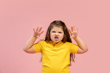 Image showing Happy caucasian little girl isolated on studio background. Looks happy, cheerful, sincere. Copyspace. Childhood, education, emotions concept