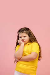 Image showing Happy caucasian little girl isolated on studio background. Looks happy, cheerful, sincere. Copyspace. Childhood, education, emotions concept