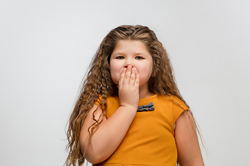 Image showing Happy caucasian little girl isolated on studio background. Looks happy, cheerful, sincere. Copyspace. Childhood, education, emotions concept