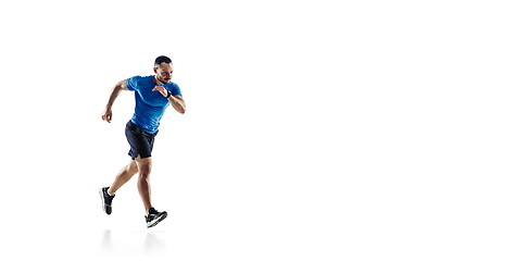 Image showing Caucasian professional male runner, athlete training isolated on white studio background. Copyspace for ad.