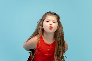 Image showing Happy caucasian little girl isolated on studio background. Looks happy, cheerful, sincere. Copyspace. Childhood, education, emotions concept