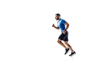 Image showing Caucasian professional male runner, athlete training isolated on white studio background. Copyspace for ad.