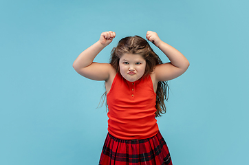 Image showing Happy caucasian little girl isolated on studio background. Looks happy, cheerful, sincere. Copyspace. Childhood, education, emotions concept