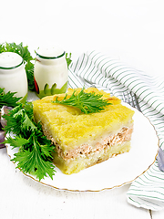 Image showing Casserole with potatoes and fish in plate on table