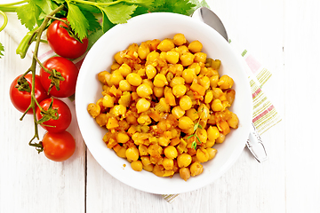 Image showing Chickpeas with vegetables stewed in plate on light board top