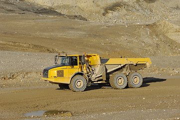 Image showing Yellow dump truck working in gravel pit