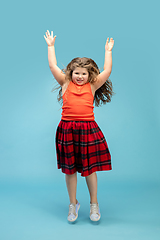 Image showing Happy caucasian little girl isolated on studio background. Looks happy, cheerful, sincere. Copyspace. Childhood, education, emotions concept